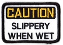 CAUTION SLIPPERY WHEN WET TYGMÄRKE