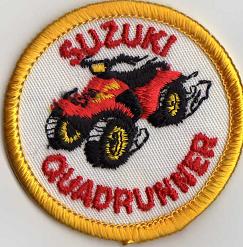 SUZUKI QUADRUNNER TYGMÄRKE 50mm